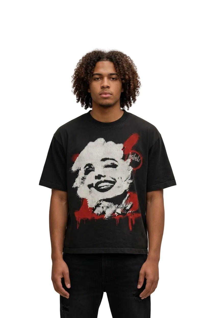Person wearing a black t-shirt with a graphic design in an urban setting